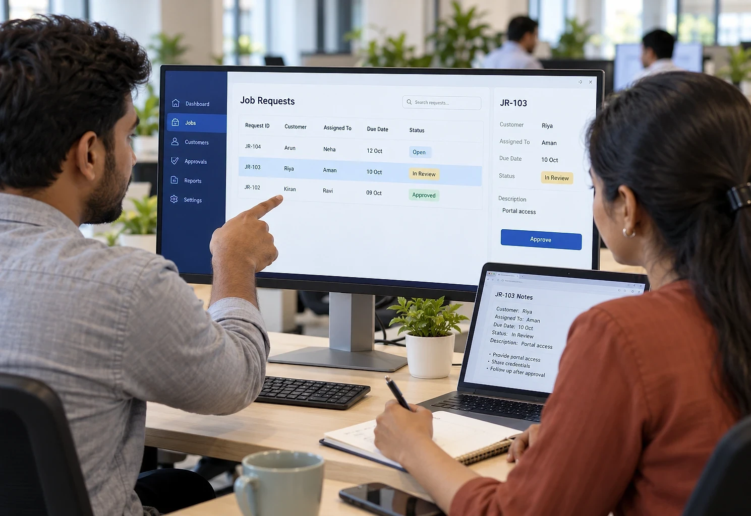 Two engineers reviewing job requests in a custom business web application