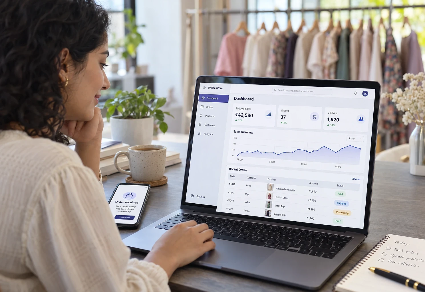 Fashion brand owner checking today's sales and recent orders in her online store dashboard