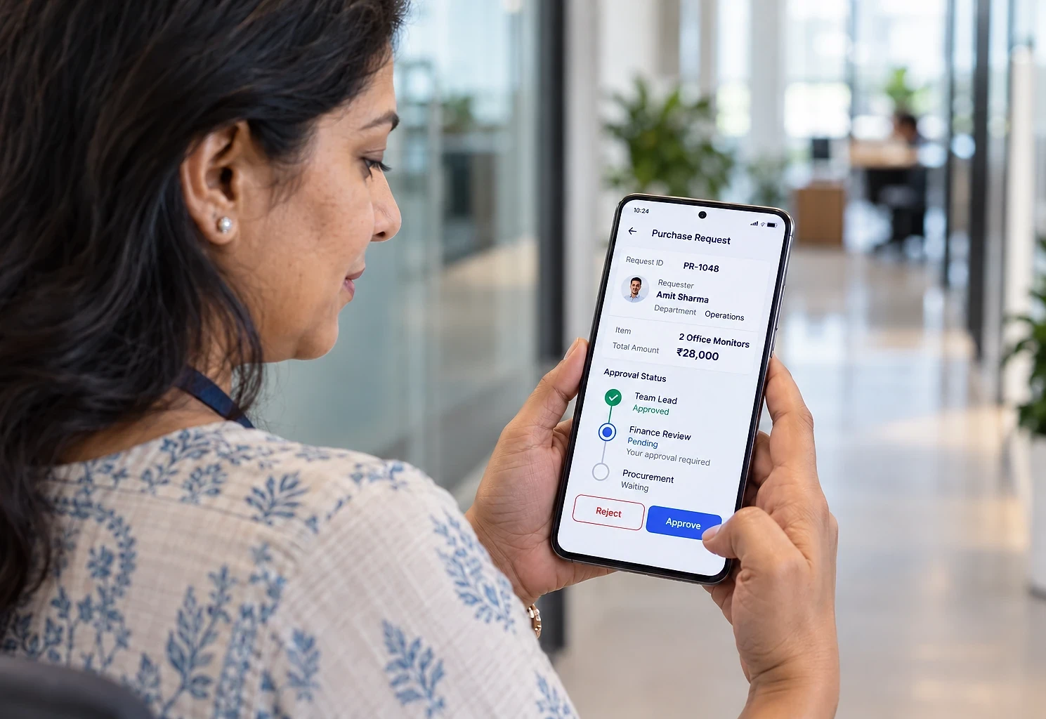 Finance manager approving a purchase request on her phone