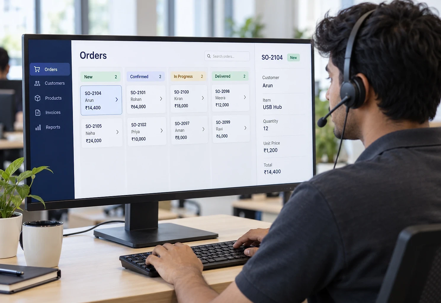 Sales coordinator on a headset working through an order board on a wide monitor