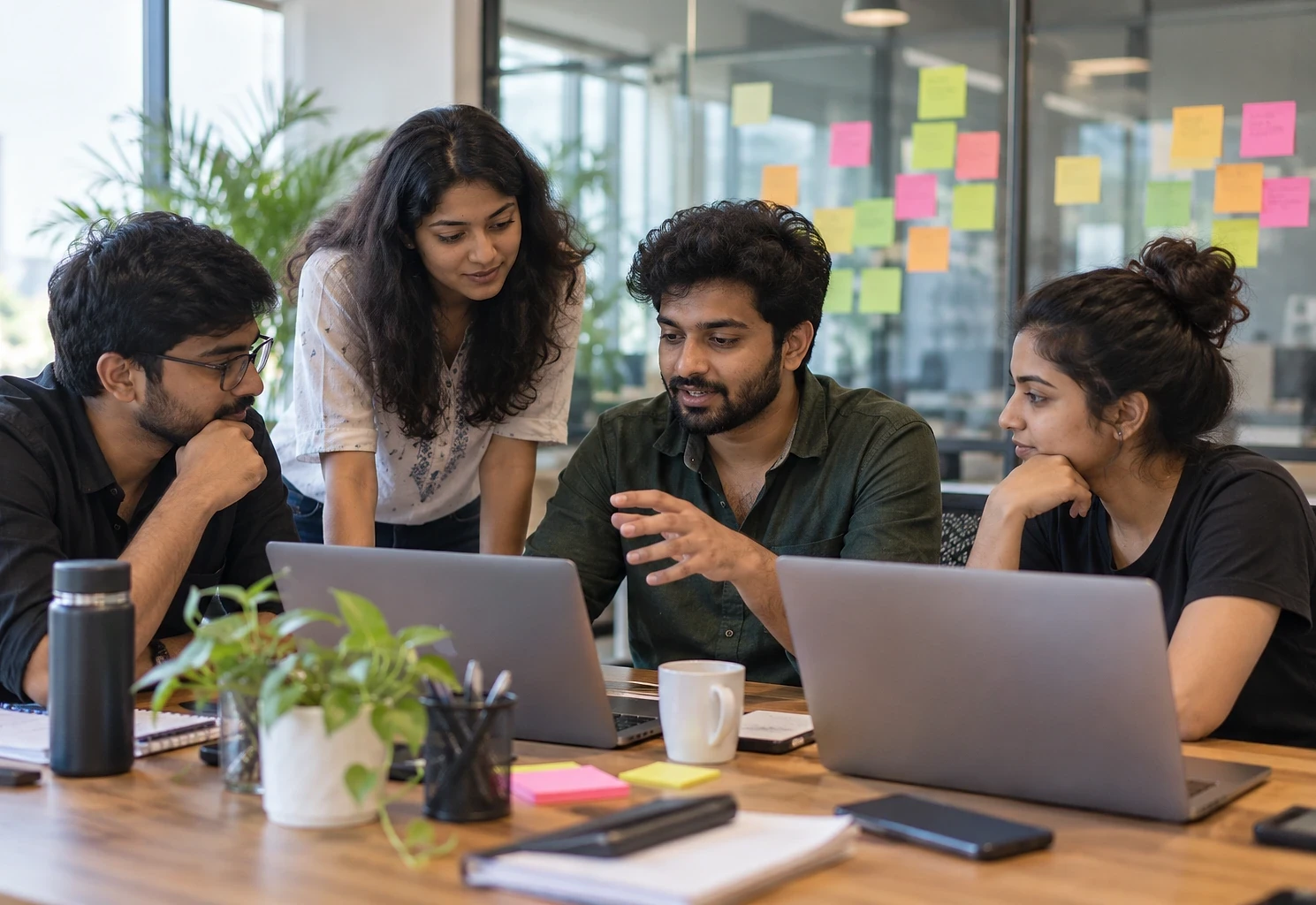 Small startup team working together around a shared table